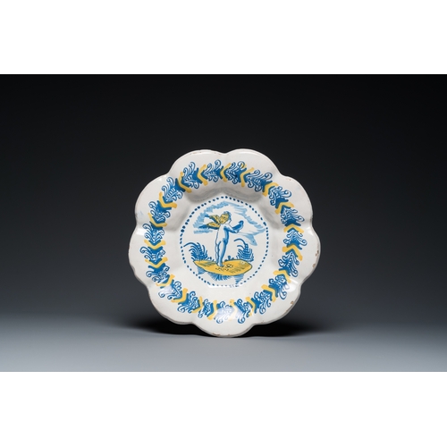 1295 - A blue, white and yellow Dutch Delftware dish with a putto holding a falcon, Delft or Haarlem, 17th ... 