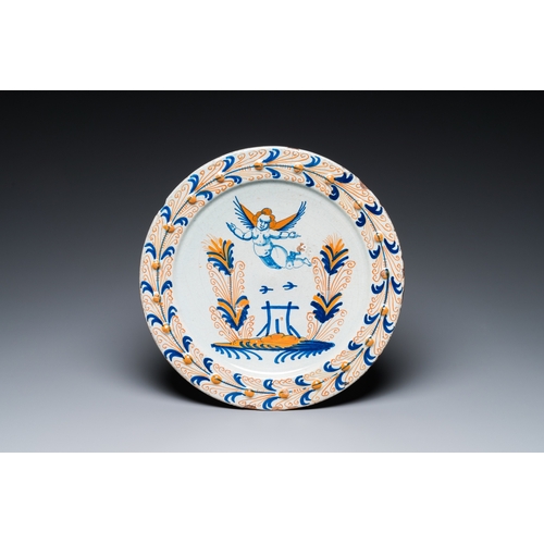 1296 - An exceptional polychrome Dutch maiolica dish with a flying putto above a fence, probably Haarlem, 1... 