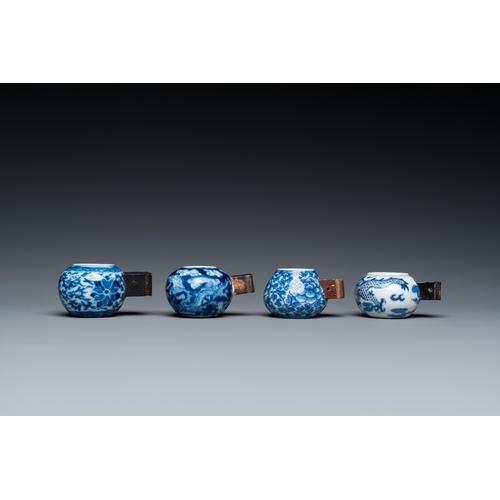 25 - Four Chinese blue, white and copper-red bird feeders, 19th C.L.: 6 cm - H.: 3 cm (the largest incl. ... 