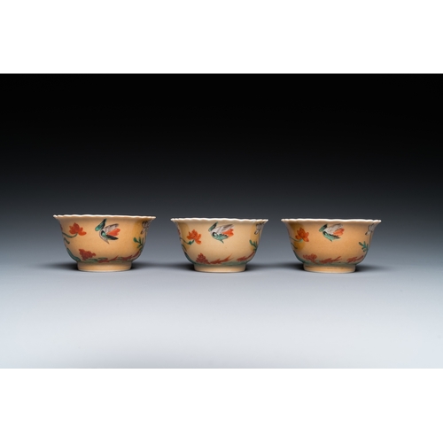 77 - Three Chinese Kangxi-style cafe-au-lait-ground famille verte cups and saucers, rabbit mark, 19th C.D... 