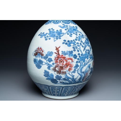 129 - A Chinese blue, white and copper-red bottle vase with a deer and birds among blossoming branches, 19... 