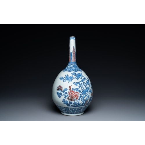 129 - A Chinese blue, white and copper-red bottle vase with a deer and birds among blossoming branches, 19... 