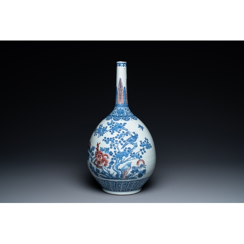 129 - A Chinese blue, white and copper-red bottle vase with a deer and birds among blossoming branches, 19... 