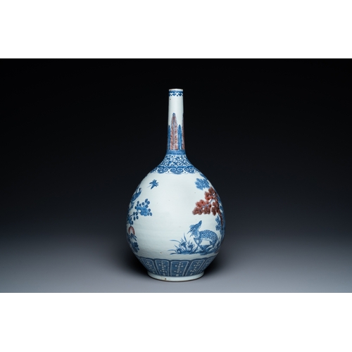 129 - A Chinese blue, white and copper-red bottle vase with a deer and birds among blossoming branches, 19... 