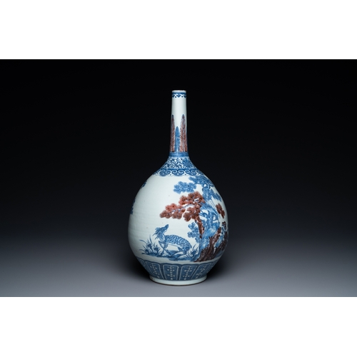 129 - A Chinese blue, white and copper-red bottle vase with a deer and birds among blossoming branches, 19... 