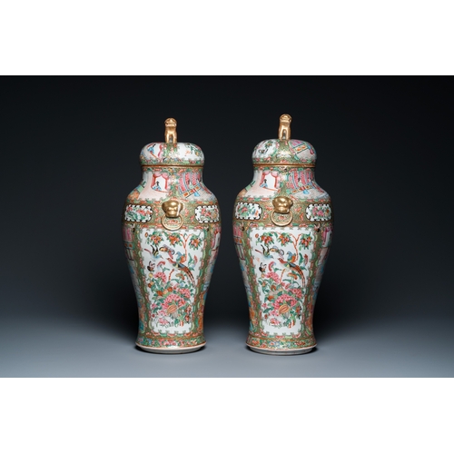 156 - A pair of Chinese Canton famille rose vases and covers, 19th C.H.: 51 cm