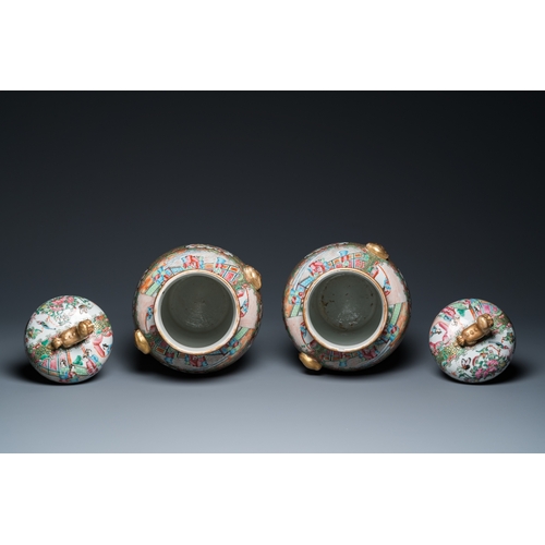 156 - A pair of Chinese Canton famille rose vases and covers, 19th C.H.: 51 cm