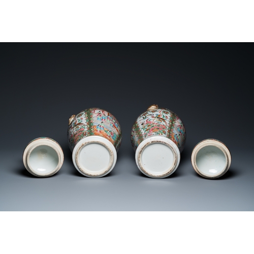 156 - A pair of Chinese Canton famille rose vases and covers, 19th C.H.: 51 cm