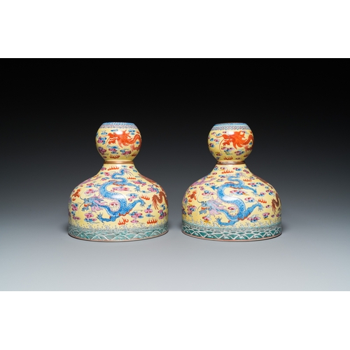 159 - A pair of Chinese famille rose yellow-ground 'dragon' vases, Qianlong mark, 20th C.H.: 25 cm... 