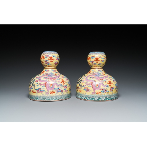 159 - A pair of Chinese famille rose yellow-ground 'dragon' vases, Qianlong mark, 20th C.H.: 25 cm... 