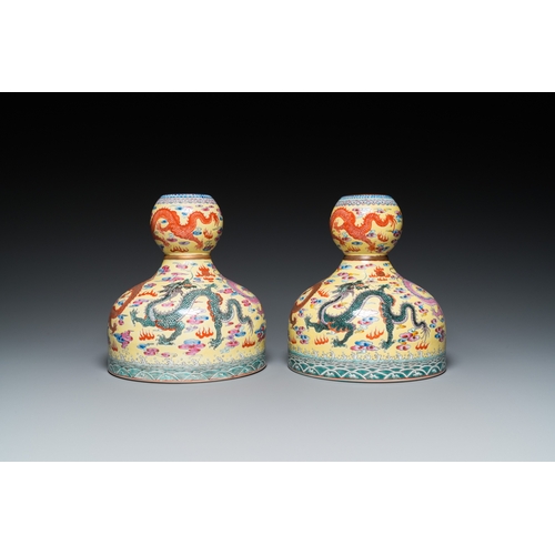 159 - A pair of Chinese famille rose yellow-ground 'dragon' vases, Qianlong mark, 20th C.H.: 25 cm... 