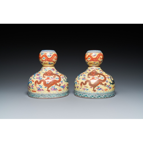 159 - A pair of Chinese famille rose yellow-ground 'dragon' vases, Qianlong mark, 20th C.H.: 25 cm... 