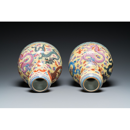 159 - A pair of Chinese famille rose yellow-ground 'dragon' vases, Qianlong mark, 20th C.H.: 25 cm... 