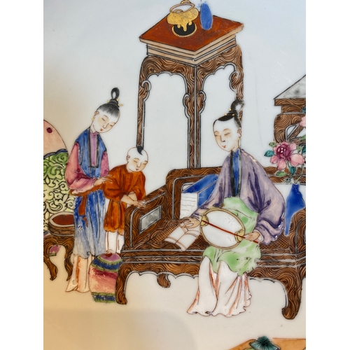 220 - A fine Chinese famille rose eggshell porcelain plate with a boy and two governesses in an interior, ... 