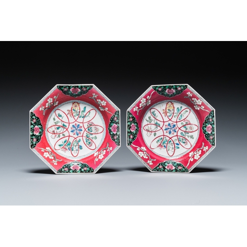 297 - A pair of Chinese octagonal famille rose ruby-ground plates, YongzhengL.: 21 cm