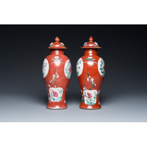 302 - A pair of Chinese famille rose ruby-ground vases and covers, Yongzheng/QianlongH.: 28 cm... 