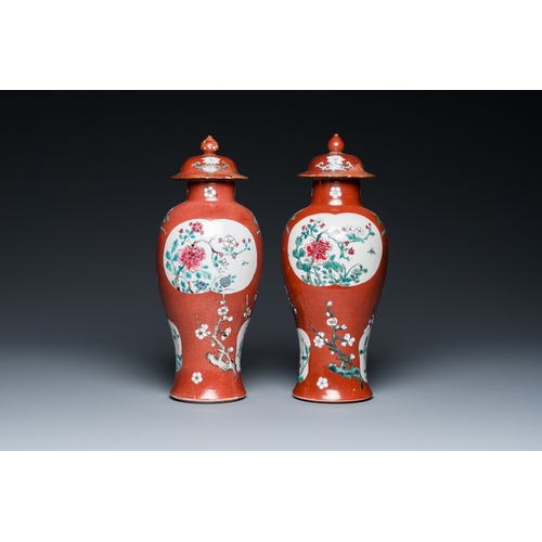 302 - A pair of Chinese famille rose ruby-ground vases and covers, Yongzheng/QianlongH.: 28 cm... 