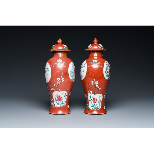 302 - A pair of Chinese famille rose ruby-ground vases and covers, Yongzheng/QianlongH.: 28 cm... 