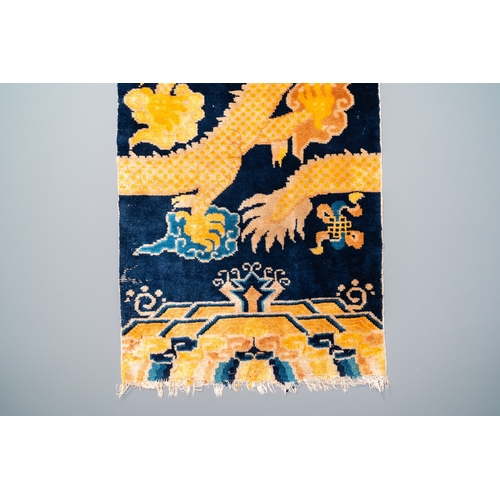 434 - A Chinese silk 'dragons' carpet, 19th C.Dim.: 183 x 74 cm (incl. frills)