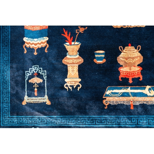 440 - A large Chinese blue-ground 'antiquities' rug, 19th C.Dim.: 264 x 183 cm (incl. frills)... 