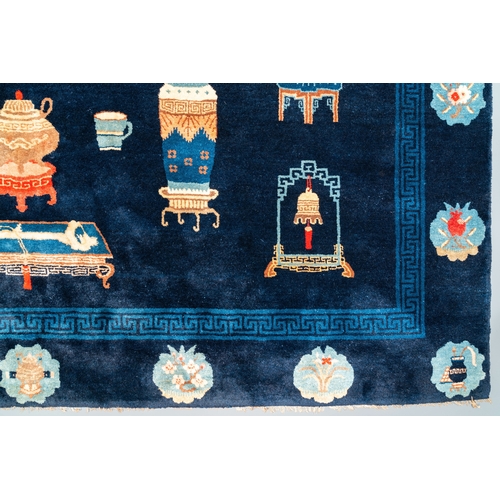 440 - A large Chinese blue-ground 'antiquities' rug, 19th C.Dim.: 264 x 183 cm (incl. frills)... 