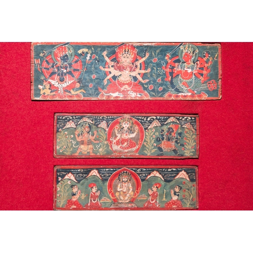 446 - Eight tsaklis and three painted wood book covers, Tibet, 19th C.Dim.: 50,5 x 40,5 cm (the frame)Dim.... 