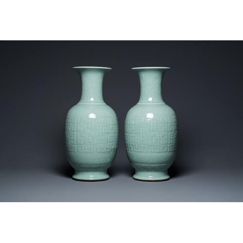 554 - A pair of Chinese monochrome celadon-glazed vases with underglaze design on wooden stands, Qianlong ... 