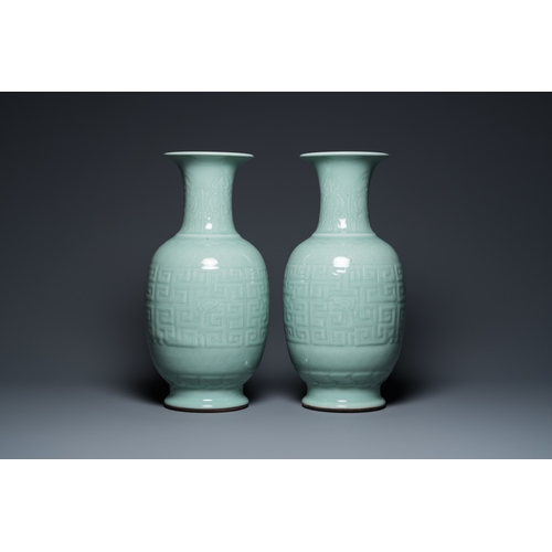 554 - A pair of Chinese monochrome celadon-glazed vases with underglaze design on wooden stands, Qianlong ... 