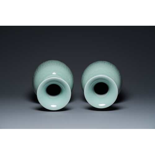 554 - A pair of Chinese monochrome celadon-glazed vases with underglaze design on wooden stands, Qianlong ... 