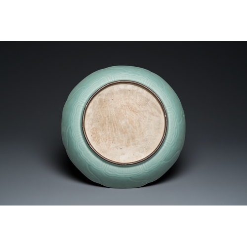 588 - A Chinese celadon-glazed 'lotus' dish, QianlongDia.: 34,5 cm
 
 Provenance: The collection of a dece... 