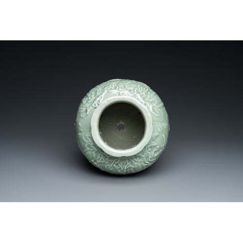 590 - A Chinese relief-molded monochrome celadon-glazed vase, 19/20th C.H.: 24,5 cm