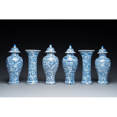 649 - A Chinese blue and white garniture of six vases with floral design, KangxiH.: 23 cm (the tallest)... 