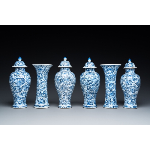 649 - A Chinese blue and white garniture of six vases with floral design, KangxiH.: 23 cm (the tallest)... 