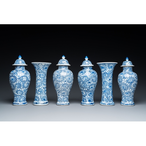 649 - A Chinese blue and white garniture of six vases with floral design, KangxiH.: 23 cm (the tallest)... 