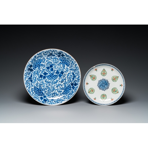 665 - A Chinese blue and white 'peony scroll' dish and a famille verte dish, KangxiDia.: 36 - 26,5 cm... 