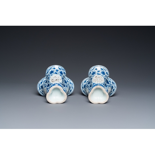 678 - A pair of Chinese reticulated and double-walled blue and white Ming-style beakers with lotus scrolls... 