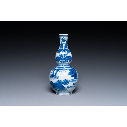 739 - A Chinese blue and white double gourd vase with a scholar and two students, Transitional periodH.: 2... 