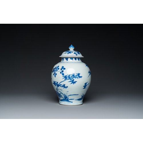 740 - A Chinese blue and white covered vase with birds among blossoming branches, Transitional periodH.: 3... 