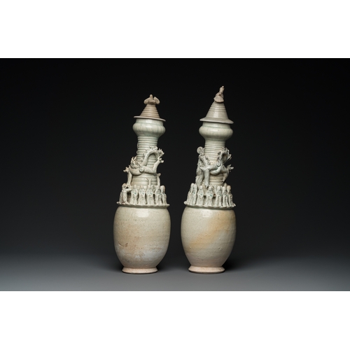 768 - Two large Chinese qingbai-glazed covered urns with applied design, Song/YuanH.: 56 cm (the tallest)... 