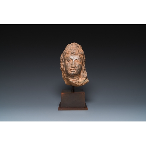 834 - A Javanese carved andesite stone head of Shiva, Indonesia, probably 8/9th C.H.: 35 cm (incl. stand) ... 