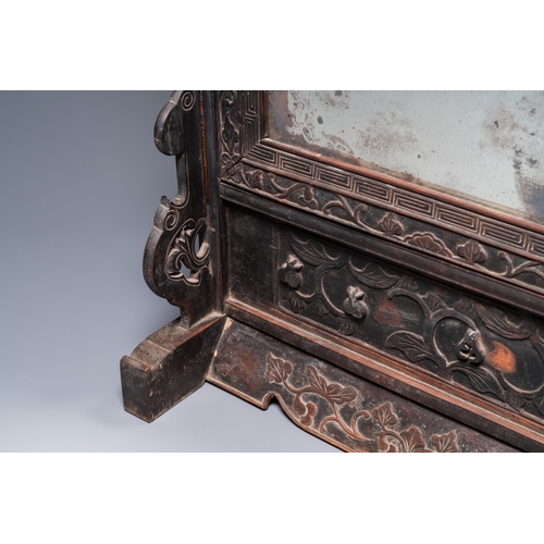 910 - A Chinese huali box and cover, a burl wood-topped stand, a table screen mirror and a pair of Buddhis... 