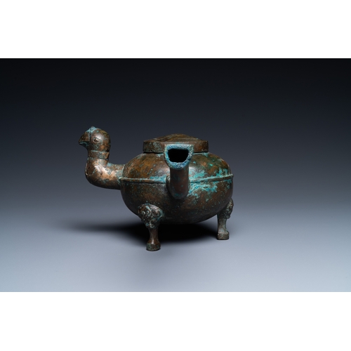 1084 - A Chinese gilt bronze tripod 'he' kettle with bird head-shaped spout, HanL.: 29 cm - H.: 13 cm
 Cond... 