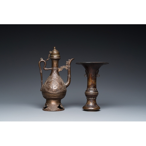 1098 - A Chinese bronze 'gu' vase and an Islamic market bronze ewer and cover, MingH.: 23,5 cm (the Islamic... 