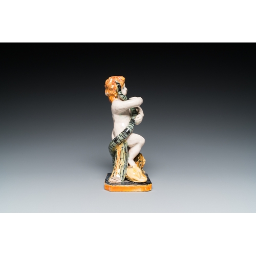 1277 - A polychrome Brussels faience sculpture of a putto with a snake standing on a lion, late 18th C.H.: ... 