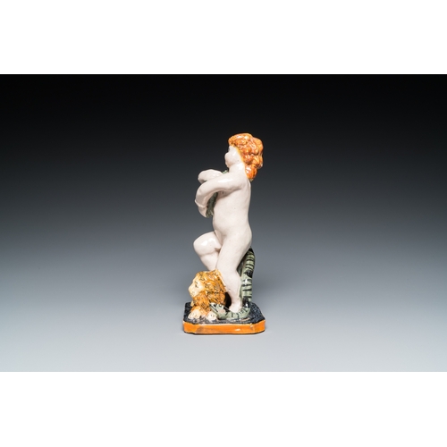 1277 - A polychrome Brussels faience sculpture of a putto with a snake standing on a lion, late 18th C.H.: ... 