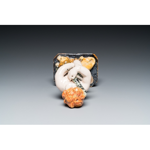 1277 - A polychrome Brussels faience sculpture of a putto with a snake standing on a lion, late 18th C.H.: ... 