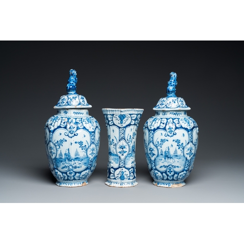 1308 - A Dutch Delft blue and white chinoiserie garniture of three vases, 18th C.H.: 34 cm (the tallest)... 