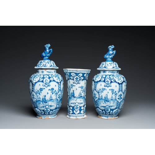 1308 - A Dutch Delft blue and white chinoiserie garniture of three vases, 18th C.H.: 34 cm (the tallest)... 