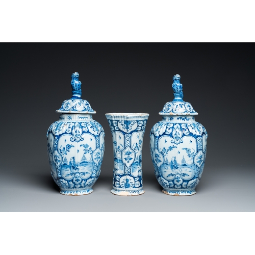 1308 - A Dutch Delft blue and white chinoiserie garniture of three vases, 18th C.H.: 34 cm (the tallest)... 