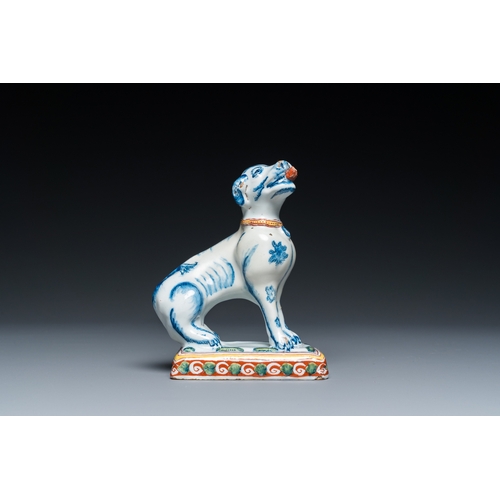 1322 - A polychrome Dutch Delft dog seated on a plinth, 18th C.H.: 12 cm
 
 Provenance:- A private collecti... 